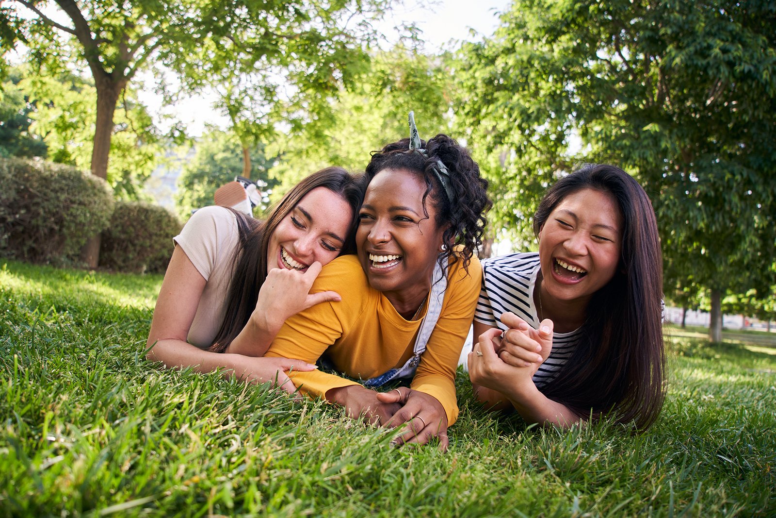 Students laughing together in the grass