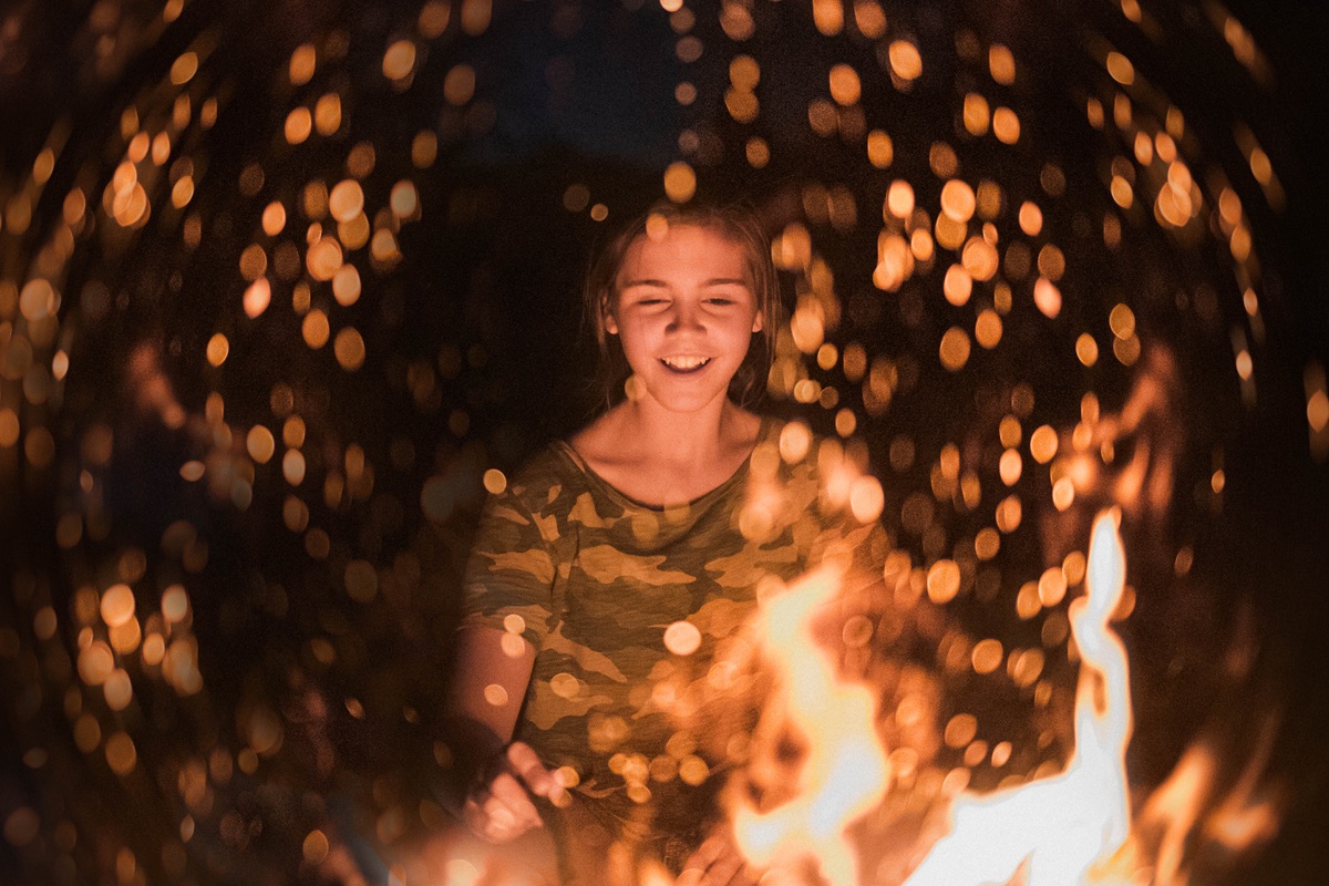 Student by a campfire